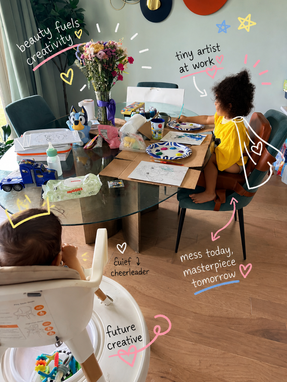 Personal photo of Jasmin's life — her kids creating art at the dining table, surrounded by paint, flowers, and hand-drawn doodles.